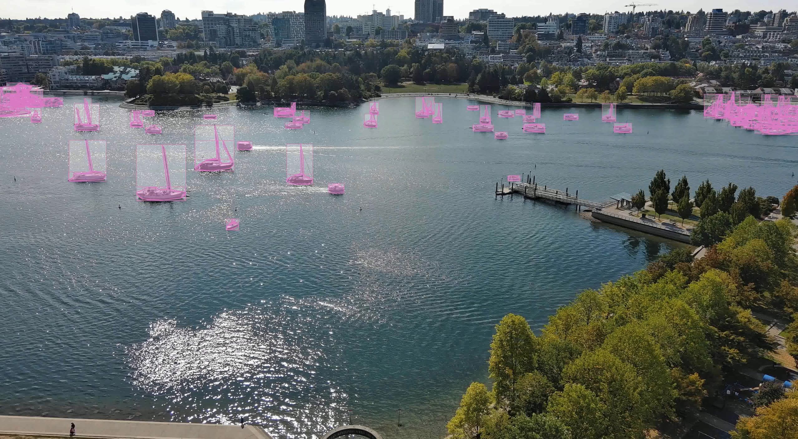 AI vessel detection with bounding boxes tracking boats across a harbour